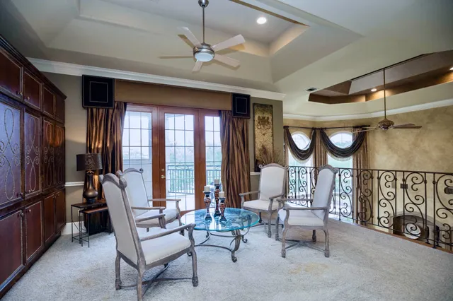 a spacious bedroom with a bed and a chandelier