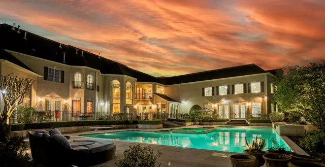 a swimming pool view with a seating space and a garden view