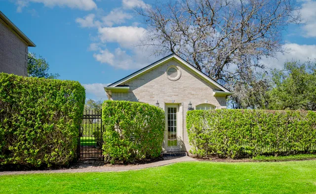 a living room with furniture a large window and wooden floor
