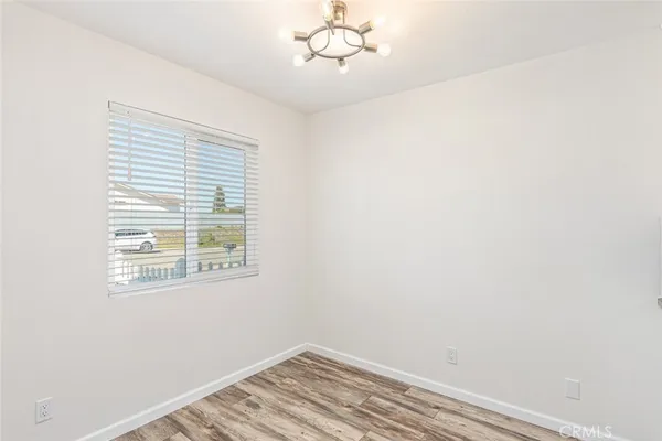 a view of a room with wooden floor and window