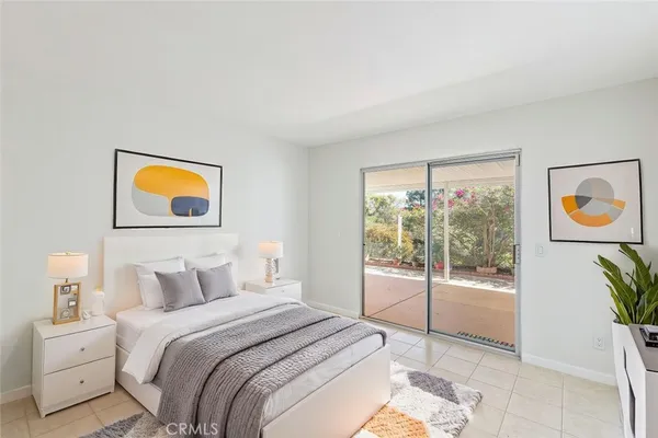 a bedroom with a bed and a painting on the wall