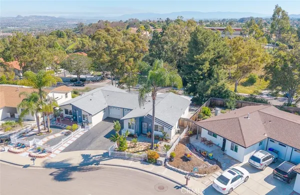 an aerial view of a house with garden space and street view