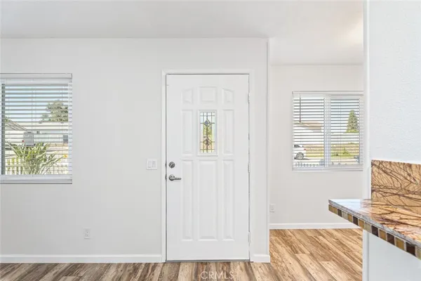 a view of a bedroom with wooden floor and a window