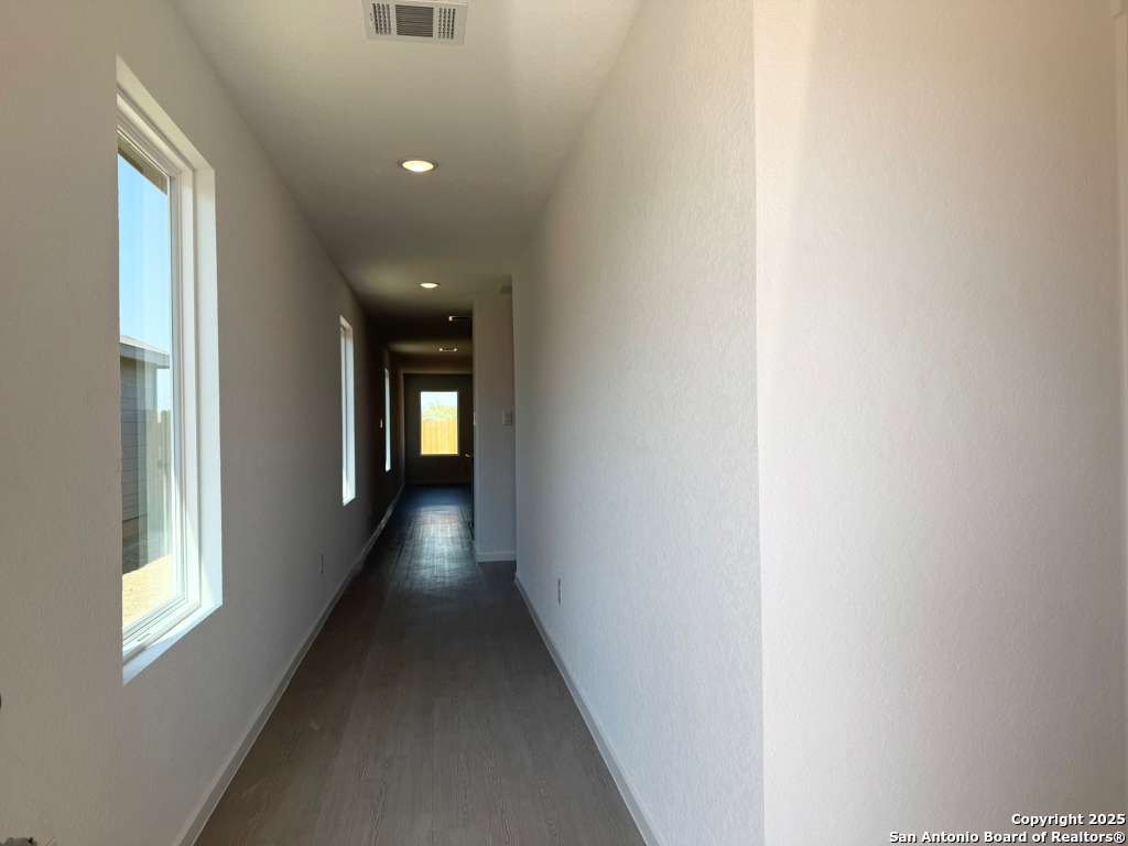 10319 Munoz Manor San Antonio, TX 78214 - Photo 2 of 13 a view of a hallway with wooden staircase