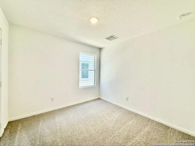 a kitchen with stove cabinets and refrigerator
