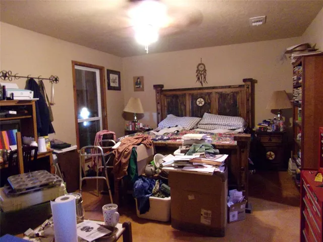 a bed room with furniture and a lamp