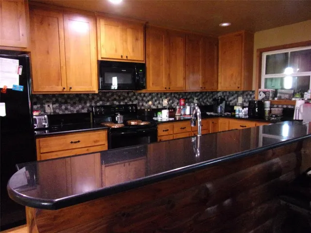 a kitchen with stainless steel appliances a stove a sink and a microwave