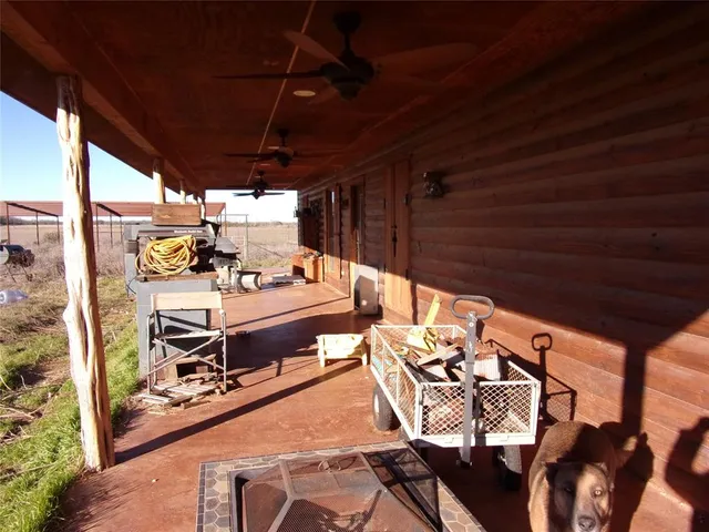 a view of a patio with table and chairs