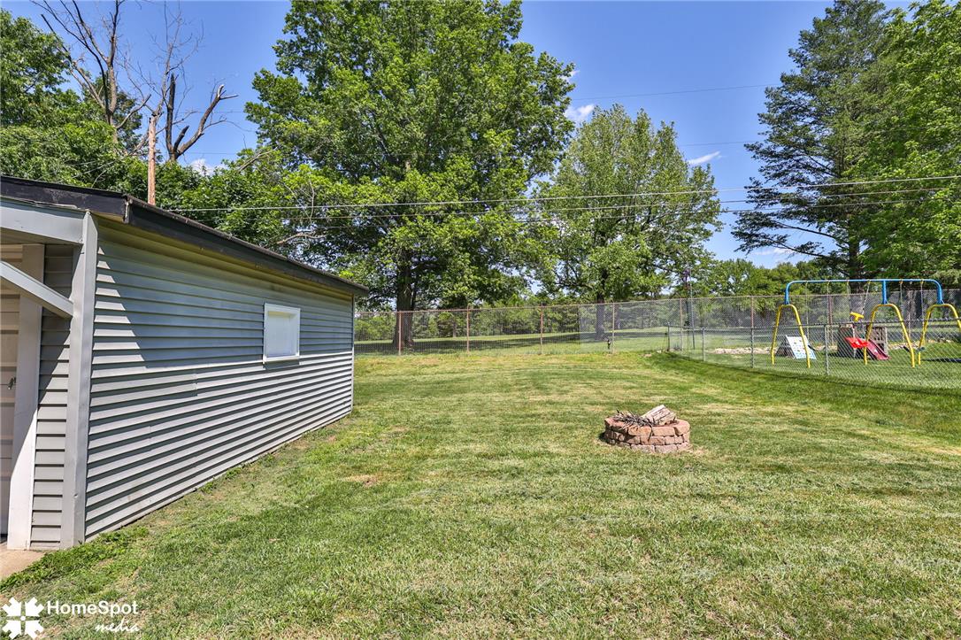415 Willow Road Hellertown, PA 18055 - Photo 23 of 25 Fenced backyard with ample green space and a dedicated fire pit for outdoor enjoyment.