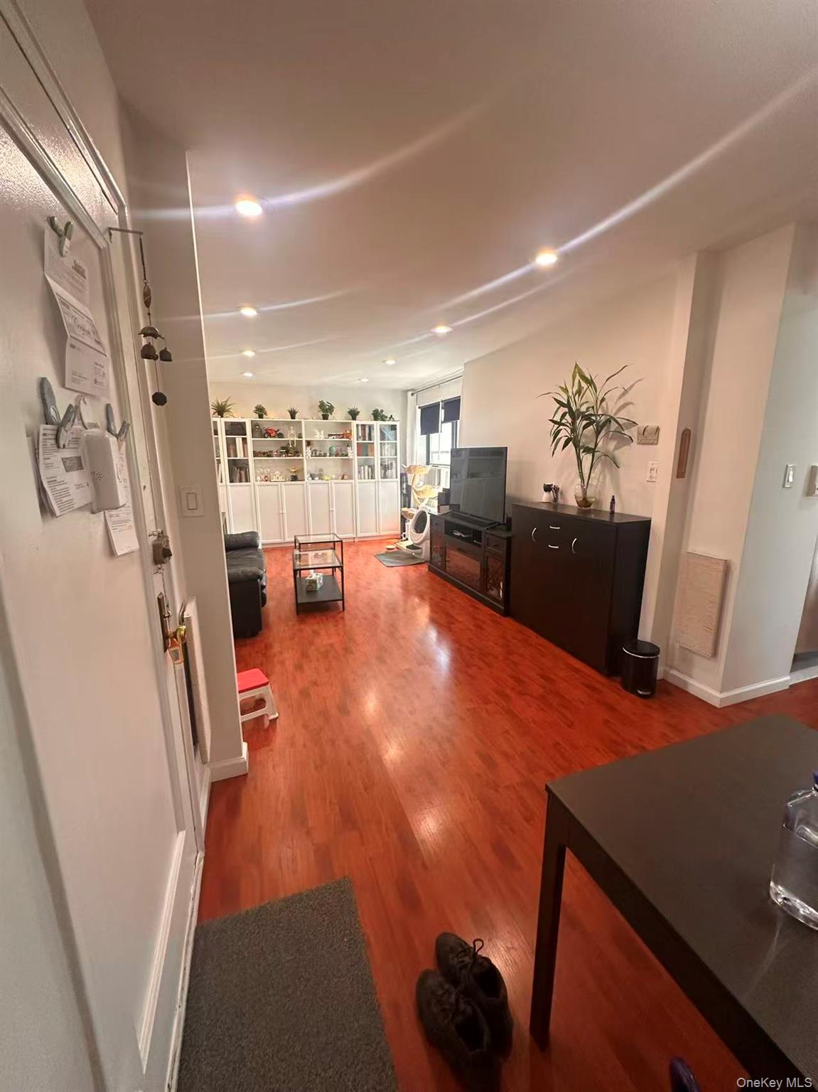 139-15 28th Road, Unit 6G Queens, NY 11354 - Photo 7 of 20 a view of a living room with furniture and a flat screen tv