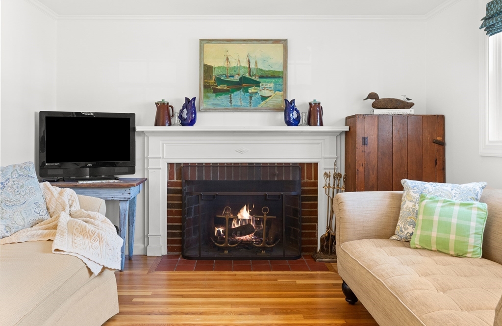 18 Conant Street Beverly, MA 01915 - Photo 17 of 40 a living room with furniture a flat screen tv and a fireplace