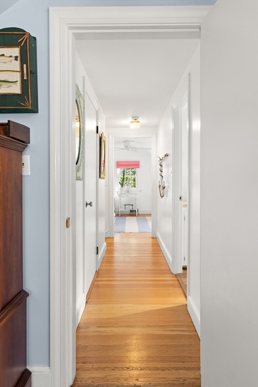 18 Conant Street Beverly, MA 01915 - Photo 22 of 40 a view of a hallway with wooden floor and windows