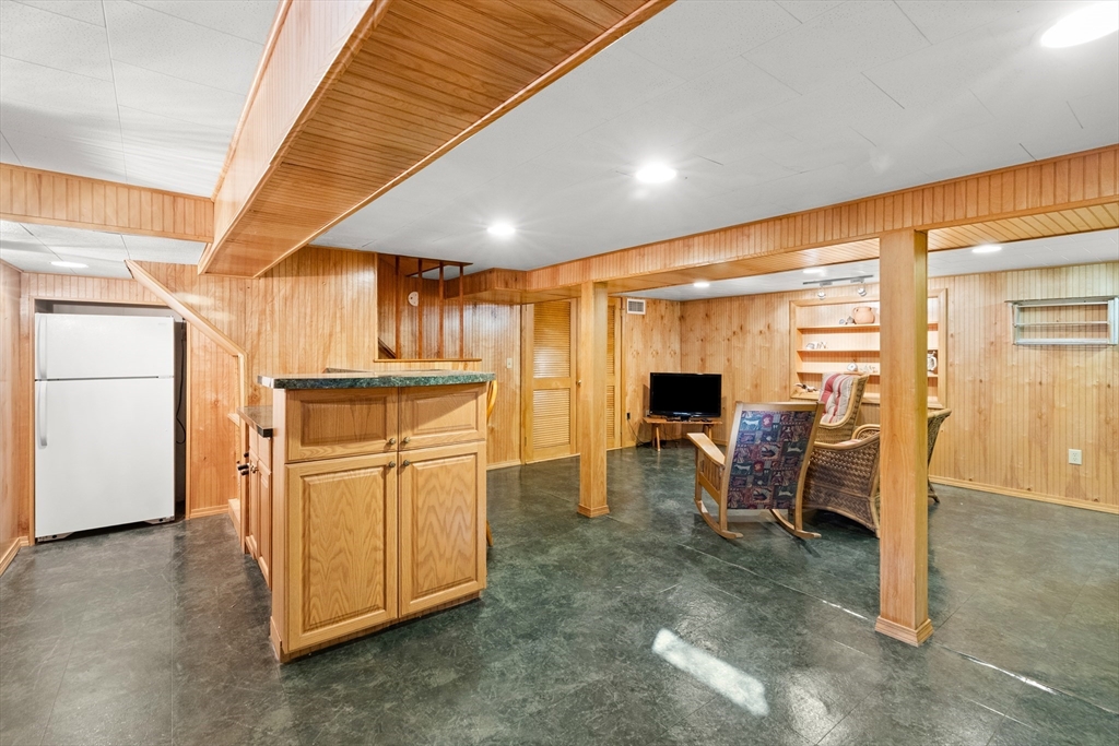 18 Conant Street Beverly, MA 01915 - Photo 32 of 40 a living room with furniture a fireplace and kitchen view