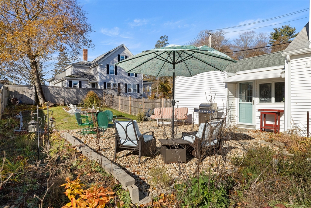 18 Conant Street Beverly, MA 01915 - Photo 35 of 40 a view of a patio with table and chairs under an umbrella