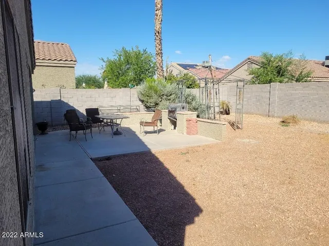 a view of a patio with table and chairs and potted plants