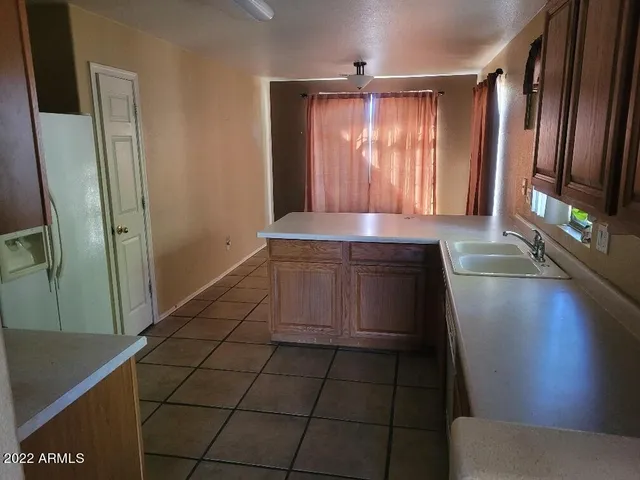 a hallway with granite countertop a couch and a stove top oven