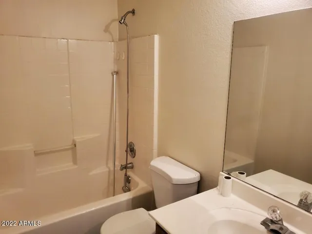 a bathroom with a toilet a sink and shower