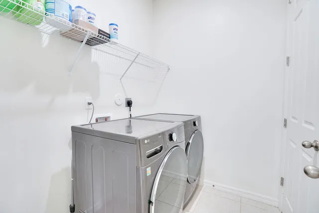 a utility room with a sink dryer and washer