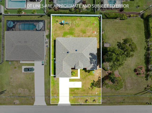 an aerial view of a house with a swimming pool