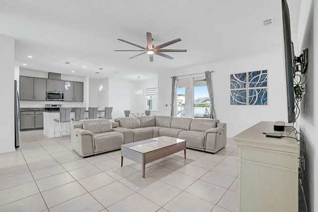 a living room with furniture and kitchen view