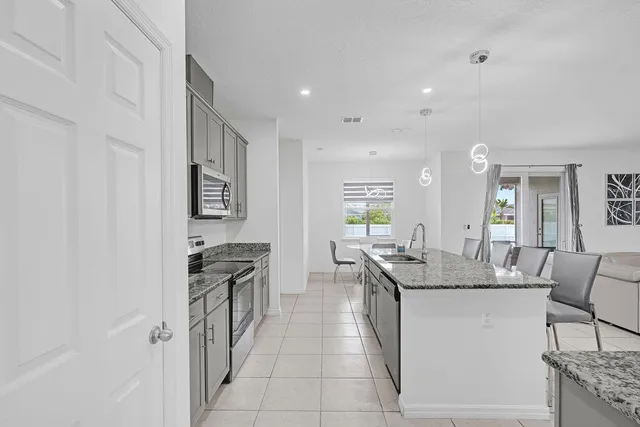 a kitchen with stainless steel appliances granite countertop a sink and cabinets