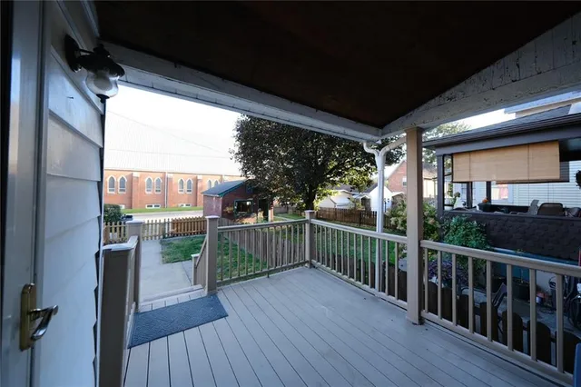 a view of a balcony with wooden floor