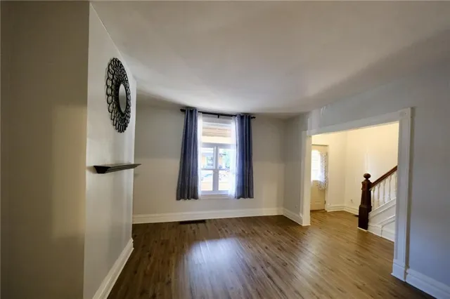 a view of a room with wooden floor and windows