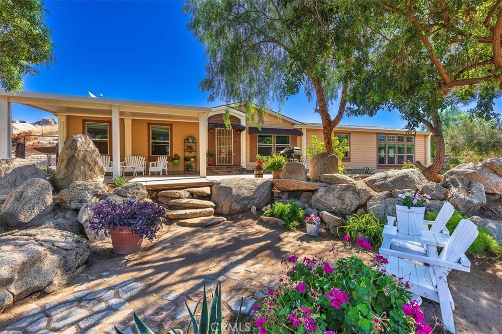 38430 Green Meadow Road Temecula, CA 92592 - Photo 1 of 1 a front view of a house with a porch and garden