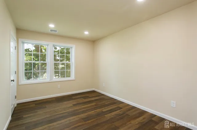 a living room with furniture a rug and a flat screen tv