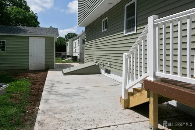 a large kitchen with kitchen island a stove a sink a refrigerator and a dining table with wooden floor