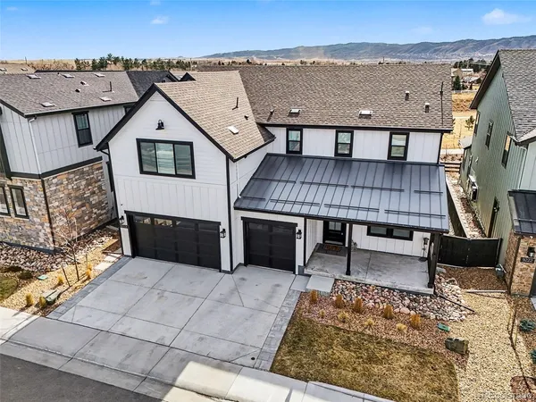 an aerial view of a house with roof deck