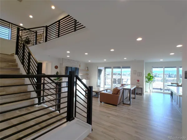 a living room with furniture wooden floor and a flat screen tv