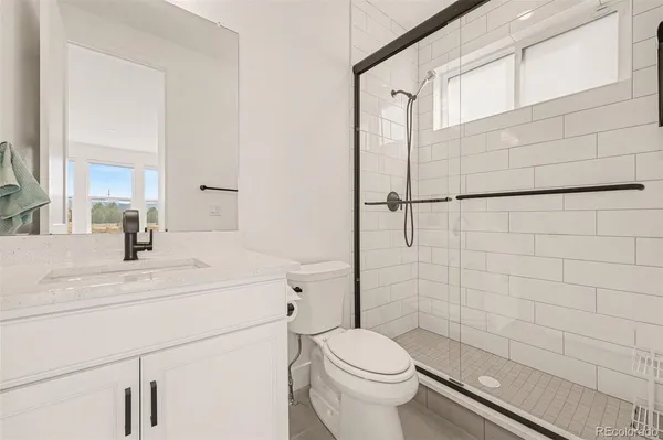 a bathroom with a sink toilet and a mirror