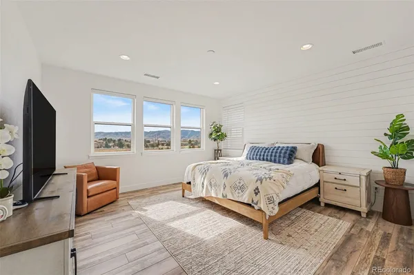 a bedroom with furniture and a flat screen tv