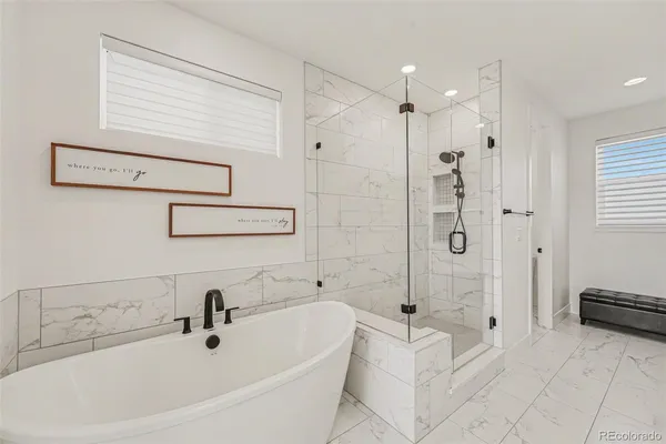 a spacious bathroom with a shower and a tub