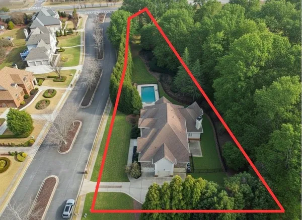 a kitchen with stainless steel appliances kitchen island granite countertop a stove top oven a sink a refrigerator and white cabinets with wooden floor
