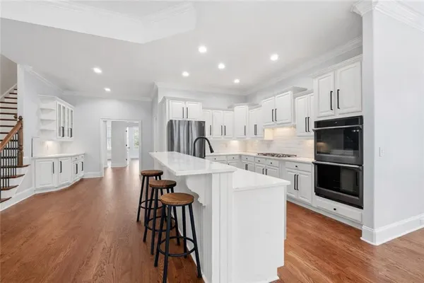a view of kitchen with refrigerator and table