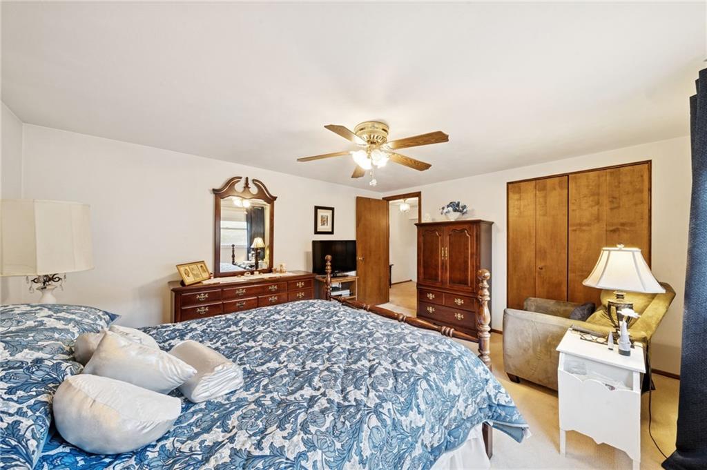 140 Possum Hollow Road Greensburg, PA 15601 - Photo 13 of 40 a bedroom with a bed and wooden floor