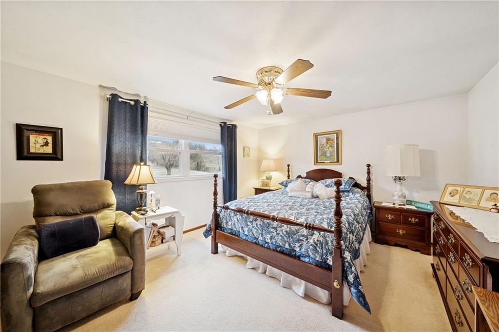 140 Possum Hollow Road Greensburg, PA 15601 - Photo 14 of 40 a bedroom with a bed couch and window