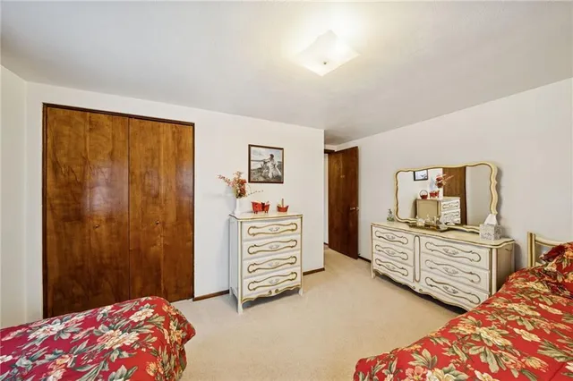 a bedroom with a bed and a dresser in it