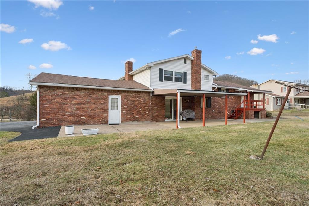 140 Possum Hollow Road Greensburg, PA 15601 - Photo 26 of 40 a view of a house with a yard and a large tree