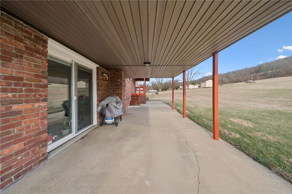 140 Possum Hollow Road Greensburg, PA 15601 - Photo 27 of 40 a view of a porch with furniture and floor to ceiling window