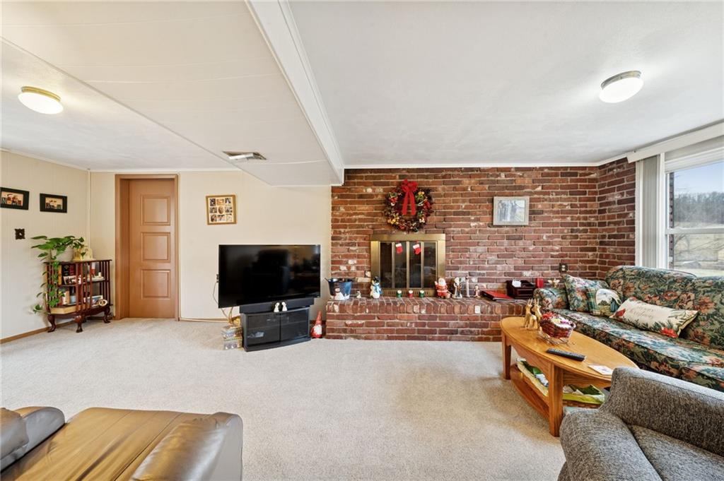 140 Possum Hollow Road Greensburg, PA 15601 - Photo 3 of 40 a living room with furniture and a flat screen tv