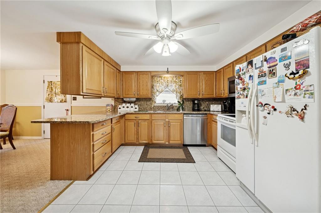 140 Possum Hollow Road Greensburg, PA 15601 - Photo 9 of 40 a kitchen with a sink window and cabinets