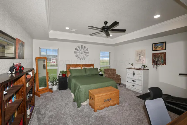 a bedroom with furniture and a fan