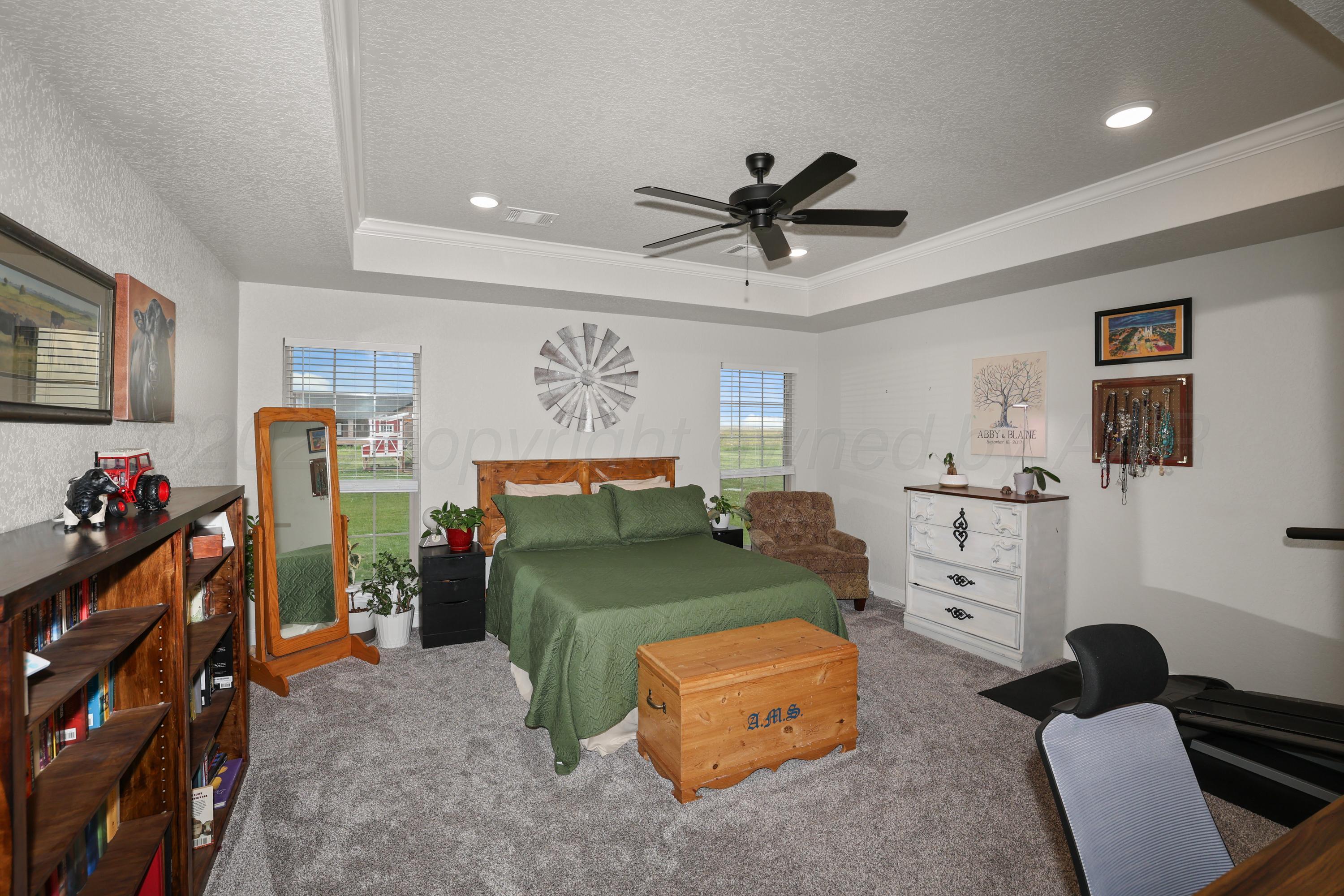 17450 Stone Creek Road Amarillo, TX 79124 - Photo 14 of 30 a bedroom with furniture and a fan