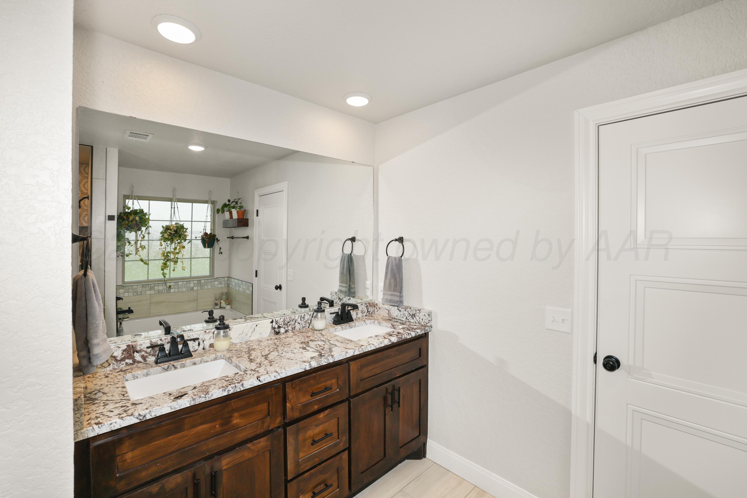 17450 Stone Creek Road Amarillo, TX 79124 - Photo 18 of 30 a bathroom with a sink double vanity and a mirror