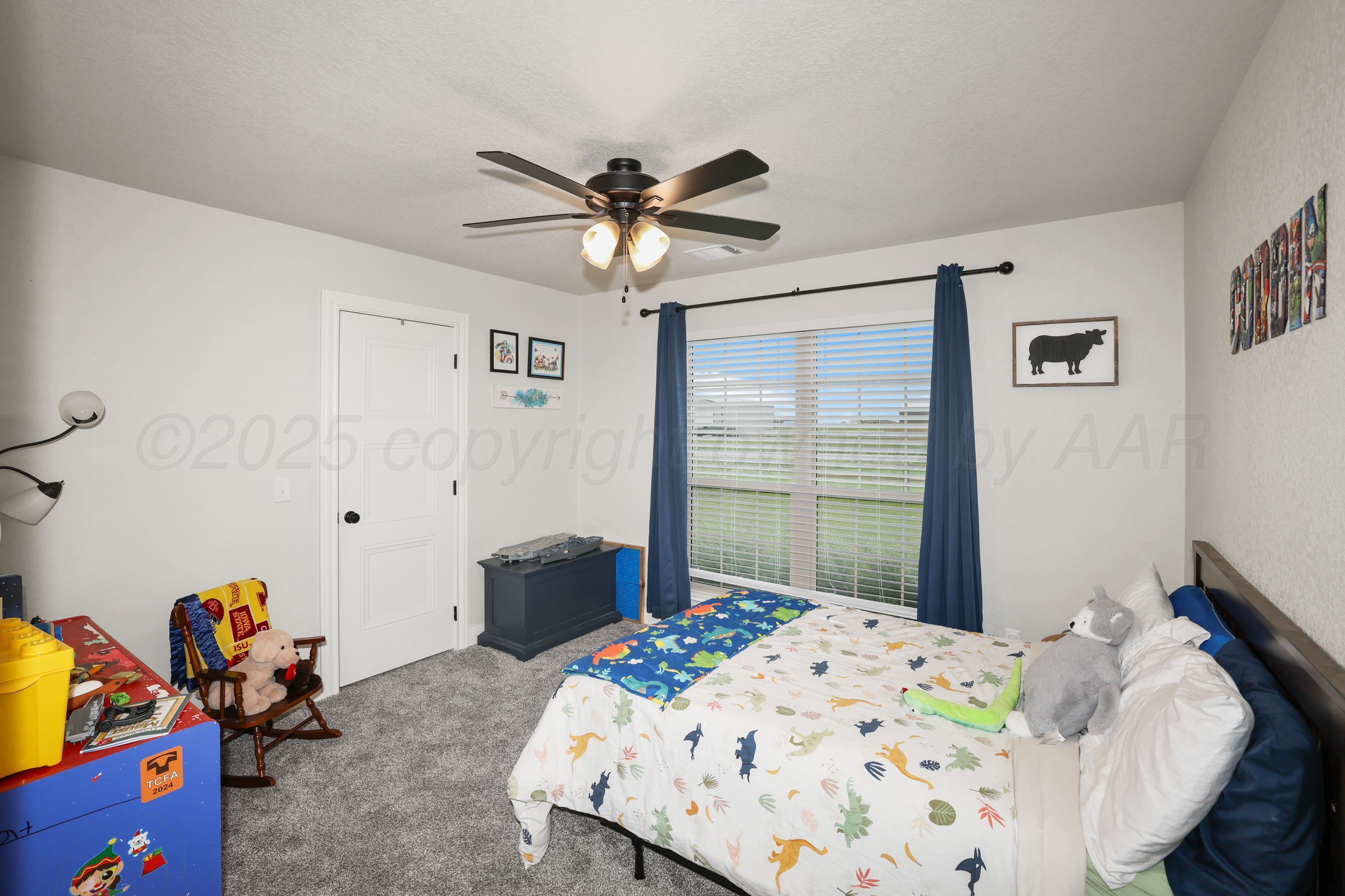 17450 Stone Creek Road Amarillo, TX 79124 - Photo 19 of 30 a bedroom with a bed and a chandelier