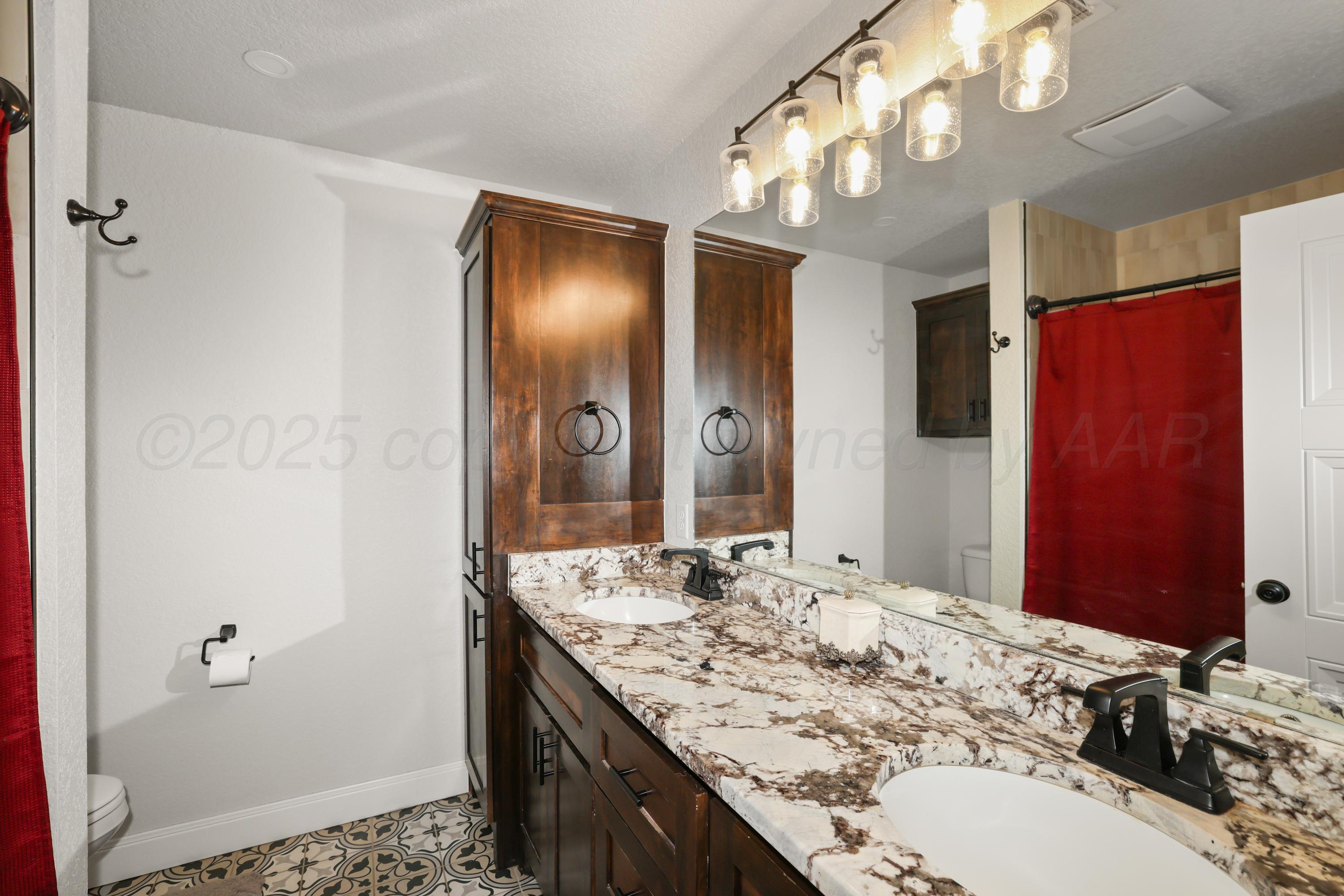 17450 Stone Creek Road Amarillo, TX 79124 - Photo 25 of 30 a bathroom with a double vanity sink and a mirror