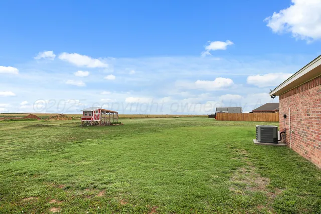 a view of a green field with clear sky